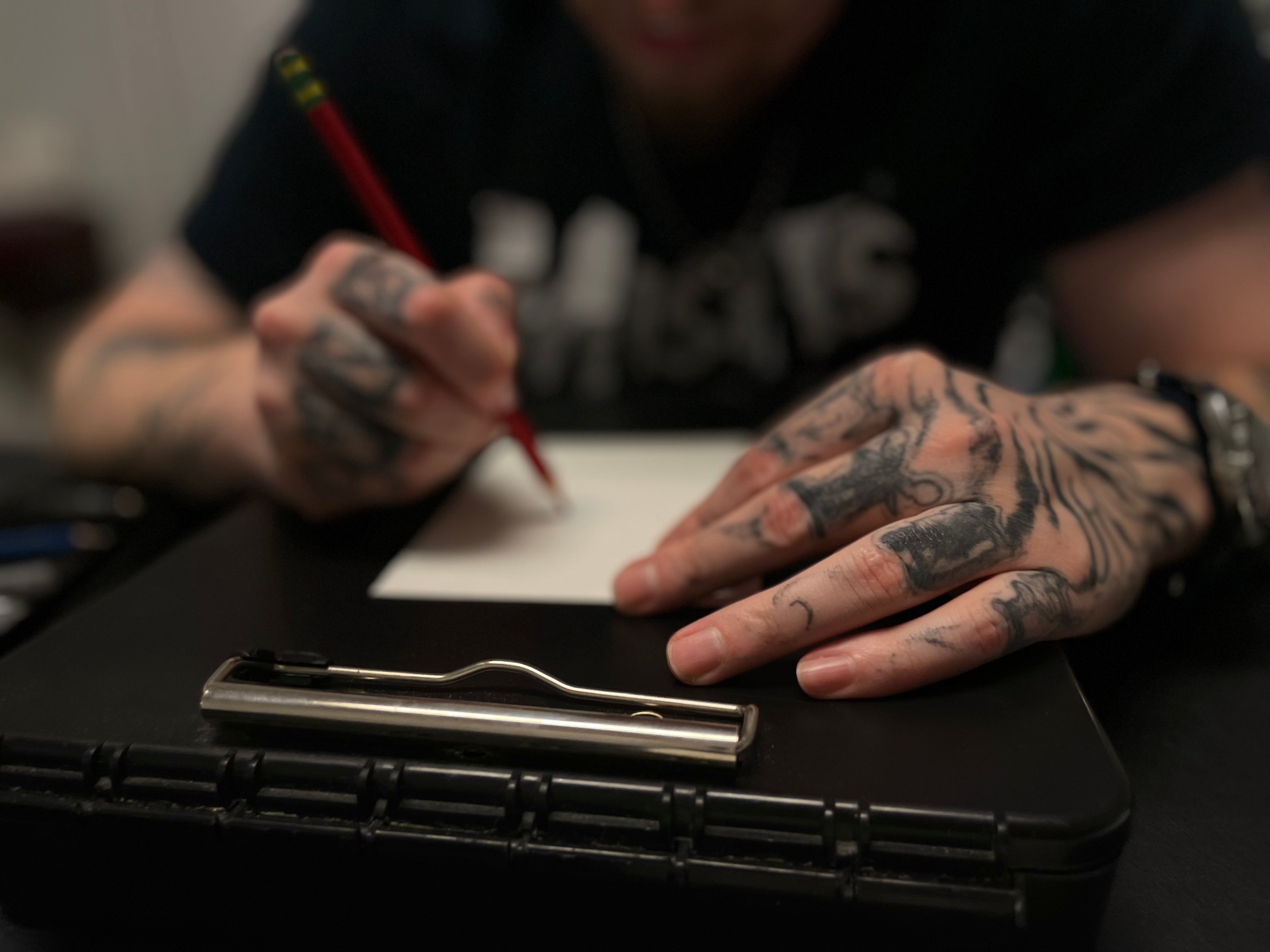 Weathered looking hands holding a pencil